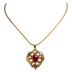 A 22K gold pendant with precious and semi-precious gemstones depicting the Nava Ratna mythology on one side and kundan gold and enamel work depicting flowers on the reverse. The pendant hangs from a hand-rolled 22K gold chain which has a screw-off end to allow for interchanging pendants. The pendant itself measures .75" x 1.75" on a 16.5" chain. India, Mid 1900's. The mythology of the Nava Ratna is quite auspicious, royal and sacred to most Asian countries, regardless of differences in culture and religion. It brings balance and benefit to the wearer. The stones relate to deities and celestial bodies. The following is a translation: 1. Ruby for Surya (Sun), 2. Pearl for Chandra (Moon), 3. Red Coral for Mangala (Mars), 4. Emerald for Budha (Mercury), 5. Yellow sapphire for Brhaspati (Jupite 22k Gold Chain, Asian Countries, Gold Piece, Fine Jewelry Collection, Yellow Sapphire, Sun And Moon, Red Coral, Precious Gemstones, Nantucket