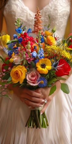 a woman holding a bouquet of flowers in her hands