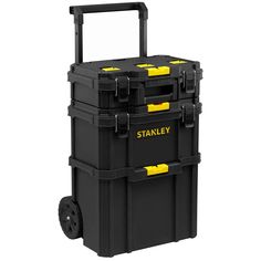 the stanley tool box is black and has two yellow handles on each side of it