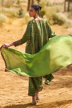 Kachha aam kaftan style tunic with bandhani print and resham and coin embroidery. Paired with a pant and dupatta.
Components: 3
Pattern: Embroidered, Printed
Type Of Work: Resham, Coin
Neckline: V Neck
Sleeve Type: Three-quarter
Fabric: Satin Silk
Color: Green
Occasion: Mehendi and Haldi - Aza Fashions Festive Traditional Pattern Maxi Length Kaftan, Bohemian Silk Sharara For Summer, Festive Maxi Length Kaftan With Traditional Patterns, Festive Traditional Pattern Maxi Kaftan, Bohemian Traditional Wear For Eid In Maxi Length, Festive Traditional Maxi Kaftan, Bohemian Maxi Traditional Wear For Eid, Bohemian Maxi Length Dupatta For Eid, Bohemian Maxi Length Sharara For Summer