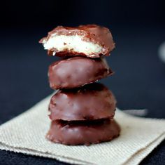 three chocolate covered cookies stacked on top of each other