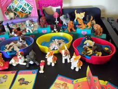 a table topped with lots of toy dogs and toys on top of eachother