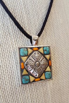 a necklace with a square design on it