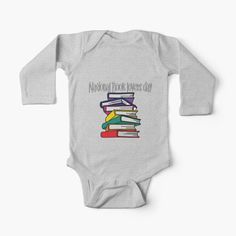 a long sleeved bodysuit with books stacked on top