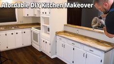 a man is sanding the kitchen cabinets in his new home with wood flooring