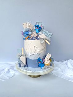 there is a cake that has blue frosting and decorations on the top, along with other items