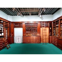 an empty room with wooden shelves and ladders