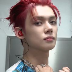 a young man with red hair and piercings