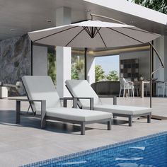 two lounge chairs under an umbrella next to a swimming pool