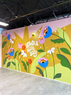 a large mural on the side of a building with flowers and leaves painted on it