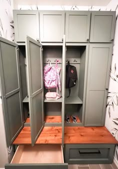 an open closet with two drawers and a backpack