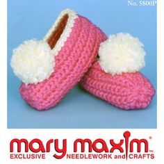 a pair of pink and white crocheted slippers with pom - poms