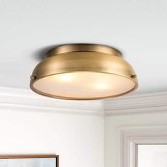 a light that is on the ceiling in a room with white walls and flooring