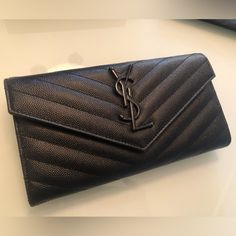 Reposhing! Bought This To Match My Ysl Bag I’m Selling. Cassandre Grain De Poudre Embossed Leather Wallet In Black Leather With Black Hardware. 4.3”H X 7.5”W X 1”D. Center Interior Zip Pocket. Box, Dust Bag, And Original Sales Receipts Included. Gently Used, No Signs Of Wear And Tear. Ysl Clutch, Saint Laurent Bags, Saint Laurent Bag, 2025 Vision, Black Hardware, Ysl Bag, Embossed Leather, Wear And Tear, Leather Wallet