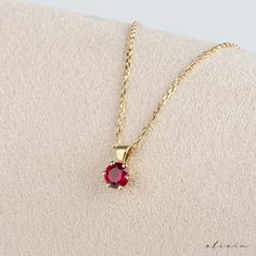 "Elevate your elegance with our Dainty Ruby Gold Pendant Necklace, featuring a captivating ruby set in 14K solid gold. Symbolizing July's birthstone, this exquisite solitaire pendant exudes timeless grace. A perfect gift for a cherished mother, celebrating her birth month with sophistication and style. F E A T U R E S 💠 G E M S T O N E Type: Ruby Carat: 0.50  ,  0.30  ,  0.15   options Cut: Round 🌟 M A T E R I A L Gold: Available in 14K and 18K Options Color: Choices of White, Rose, or Yellow Chain: Cable Closure: Spring Ring **The model on the mannequin in the images is the 0.50 carat model. 🎁 Extra Touch: As a testament to our dedication to exceptional customer service, each purchase is accompanied by a complimentary product certificate. Your order will be elegantly presented in a sty Classic Red 14k Gold Necklace, Elegant Birthstone Necklace With 17 Jewels As Gift, Elegant Gold Plated Round Birthstone Necklace, Elegant Birthstone Necklace With Polished Finish As Gift, Classic Ruby Necklace With Prong Setting, Gift Jewelry With Lab-created Ruby In Prong Setting, Classic Ruby Necklace With Diamond Cut, Yellow Gold Jewelry With Lab-created Ruby In Prong Setting, Elegant Polished Birthstone Necklace