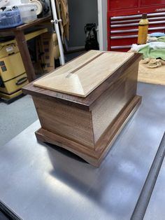 a wooden box sitting on top of a metal table