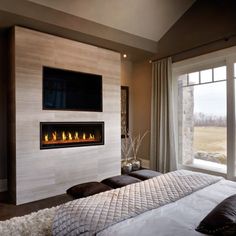 a bedroom with a large bed and a flat screen tv mounted on the wall