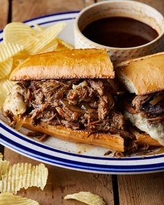 a pulled pork sandwich on a plate with chips next to it and a cup of coffee