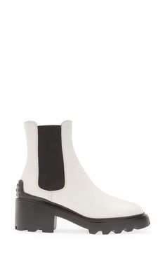 This elevated take on the Chelsea boot is distinguished by a block heel and lugged sole with pebbled tread inspired by the brand's driving shoes. 2 1/4" (57mm) heel (size 38.5) 6" shaft Pull-on style with elastic gore insets Leather and textile upper and lining/rubber sole Made in Italy Women's Designer Shoes Luxury Ankle Platform Boots With Lug Sole, Modern Ankle Boots With Lug Sole, Calf Leather Platform Boots With Lug Sole For Work, Luxury Lug Sole Boots For Work, Luxury Lug Sole Boots For Workwear, Workwear Boots With Lug Sole And Block Heel, Block Heel Heeled Boots With Lug Sole For Work, Workwear Heeled Boots With Lug Sole In Medium Width, Workwear Heeled Boots With Lug Sole And Block Heel