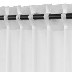 black and white photograph of curtains with the curtain rod pulled back