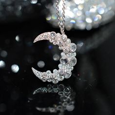 A ladies 18 karat white gold 16 inch long necklace by Vivann with a diamond crescent moon pendant containing 6 round rose cut diamonds and 30 round brilliant cut diamonds.  The total weight of all diamonds is .57 carats. White Gold Moon-shaped Jewelry For Formal Occasions, Formal Silver Moon-shaped Jewelry, Silver Crescent Jewelry For Formal Occasions, Formal White Gold Moon Shaped Jewelry, Luxury Moon Shaped Jewelry For Formal Occasions, Round Moon Phase Necklaces For Weddings, Moon Phase Round Necklaces For Weddings, Formal White Gold Moon-shaped Jewelry, Formal Crescent White Gold Jewelry