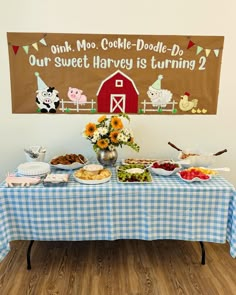 a table topped with lots of food on top of a blue and white checkered table cloth