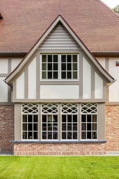 a large brick house with white trim and windows