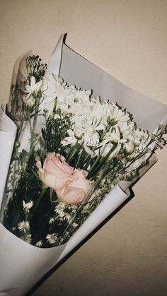 a bouquet of flowers in a white box