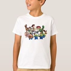 a young boy wearing a white t - shirt with toy story characters on the front