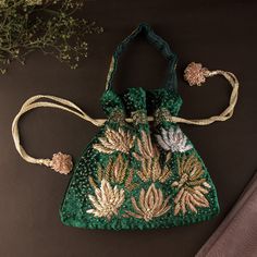 "Classic Emerald Green Wedding Evening Purse | Art Deco Lotus Embroidered Zardozi Handbag Pouch Purse | Bridesmaids Velvet Drawstring Purse Size: 10\" x 10\"(inches) Designed with the heart, this beautiful bag are eye catchy and made of premium material. Key Features: Embroidery art work. (zardosi work). This potli is good match with both Indian and western outfits and are superb for wedding and festive parties. This would be best complement to your designer saree, lenhga or any other kind of dress. This is the combination of traditional and modern embroidery work. This is enough to keep your accessories and all needed essentials and it can be a best gift for any woman." Embroidered Rectangular Potli Bag For Wedding, Wedding Festival Potli Pouch Bag, Wedding Pouch Bag With Zari Work, Wedding Zari Work Pouch Bag, Embroidered Wedding Bag For Festive Season, Wedding Potli Bag With Intricate Embroidery, Embroidered Festive Wedding Bags, Rectangular Potli Bag With Dori Work For Wedding, Festive Embroidered Wedding Bags