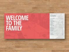 a welcome to the family sign sitting on top of a wooden floor