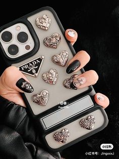 a woman's hand holding an iphone case with lots of heart shaped buttons on it