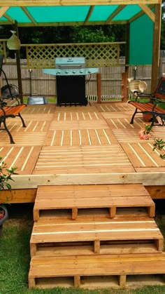 a wooden deck with benches and grill in the background