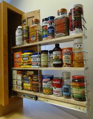 an organized spice rack in a kitchen with lots of spices and seasonings on the shelves