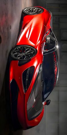 an artistic rendering of a futuristic car in red and black colors with the hood up