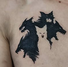 a man's chest with two black and white dogs on it