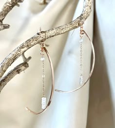 "This pair of dramatic earrings swing gracefully from the ear. They are bronze arcs in a crescent moon shape accented by a length of chain ending in gemstones(the stars!). The effect is ethereal. Available in rainbow moonstone or pyrite gems. Ear wires are 14k gold filled or sterling. Length is approx. 3.25\"." Star Wire Earrings, Elegant Moon Shaped Metal Earrings, Elegant Moon-shaped Metal Earrings, Elegant Half Moon Metal Jewelry, Elegant Half Moon Metal Earrings, Elegant Crescent Moonstone Jewelry, Elegant Half Moon Brass Jewelry, Elegant Crescent Hoop Earrings With Moon Charm, Elegant Moon-shaped Pierced Hoop Earrings