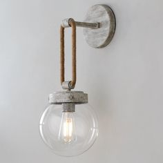 a light that is on the wall with a rope attached to it's side