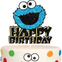 a birthday cake with a sesame character topper