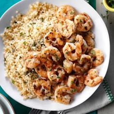 a white plate topped with shrimp and rice