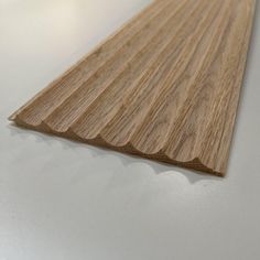 a close up view of a wooden flooring board with the edge cut in half