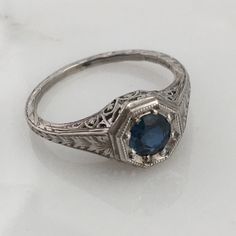 Details: Stunning Art Deco Period platinum and sapphire ring--would make a lovely wedding ring! The center stone is estimated .40 carats, and measures 4.9mm round. The filigree is beautiful on this ring, and is in lovely shape. This is a stunning ring--you will not be disappointed! Please ask all necessary questions prior to placing an order. Measurements: The size is 5 1/2 US and can be sized for a fee. Condition: The overall all condition of this ring is very good. Classic Sapphire Halo Ring, Timeless Sapphire Solitaire Promise Ring, Timeless Sapphire Ring With Accent Stones For Formal Occasions, Classic Sapphire Birthstone Ring, Classic Sapphire Birthstone Ring With Gemstone, Art Deco Oval Sapphire Ring With Accent Stones, Classic Sapphire Diamond Promise Ring, Timeless Lab-created Sapphire Diamond Wedding Ring, Classic Sapphire Ring With Lab-created Gemstone