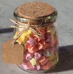 a jar filled with lots of different colored confetti