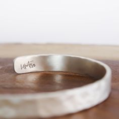 Hammered Silver Cuff 1/4" This Hammered Silver Cuff shines with the allure of a sunlit peak. Its versatility makes it perfect for everyday wear, enhancing any ensemble with a touch of understated sophistication.It's more than just adornment; it's a canvas for your personal story. With the option to personalize it, you can engrave a secret message, a cherished mantra, or a reminder of your own strength – keeping it close to your wrist as a source of inspiration. Let the Hammered Silver Cuff Brace Engraved Adjustable Sterling Silver Cuff Bracelet, Engraved Sterling Silver Adjustable Cuff Bracelet, Elegant Adjustable Stamped Cuff Bracelet, Modern Jewelry With Adjustable Band As Gift, Modern Jewelry With Adjustable Band For Gift, Adjustable Stamped Sterling Silver Bangle, Modern Jewelry Gift With Adjustable Band, Adjustable Sterling Silver Bangle For Everyday, Adjustable Everyday Sterling Silver Bangle Bracelet