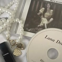 a cd, necklace, and other items on a table