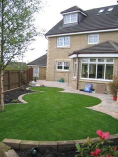 a house with a large lawn in the front yard