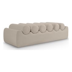 an upholstered couch with six pillows on the back and four round cushions on the top