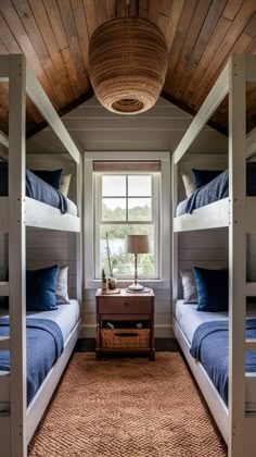 two bunk beds in a room with wooden ceiling