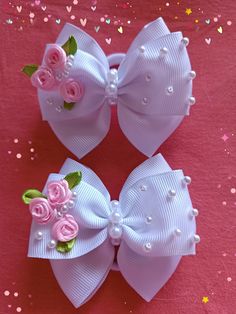 two bows with flowers and pearls on them