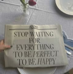 a newspaper with the words stop waiting for everything to be perfect to be happy